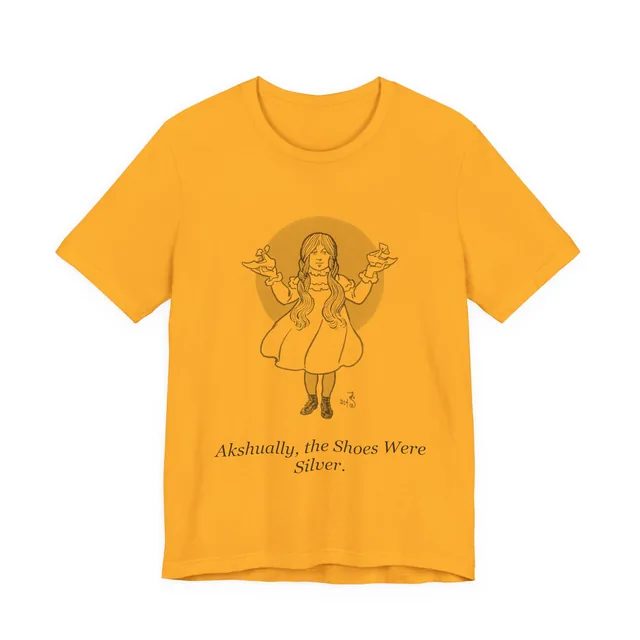 Akshually, the Shoes Were Silver. — The Wonderful Wizard of Oz design printed on a gold t-shirt
